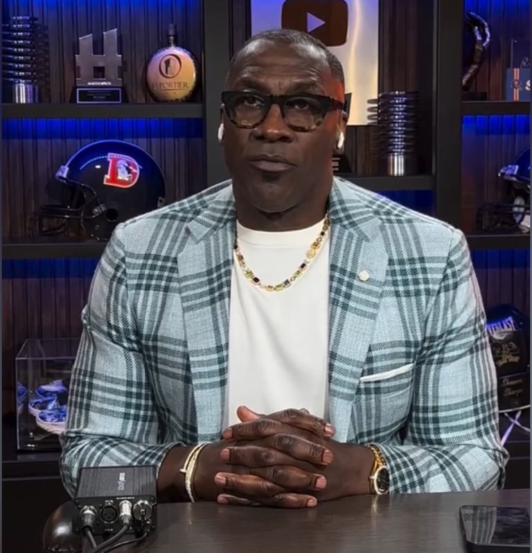 a man in a white shirt and a plaid blazer