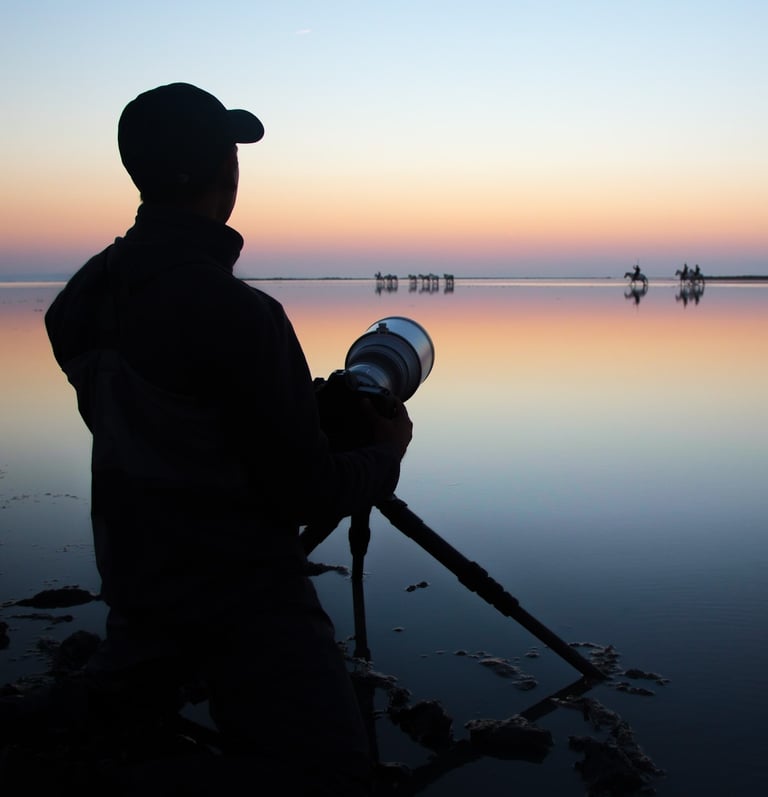 a photographer with a hat and holding a camera