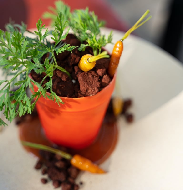 a dessert of a potted carrot cake plant that looks real by Paola Marocchi