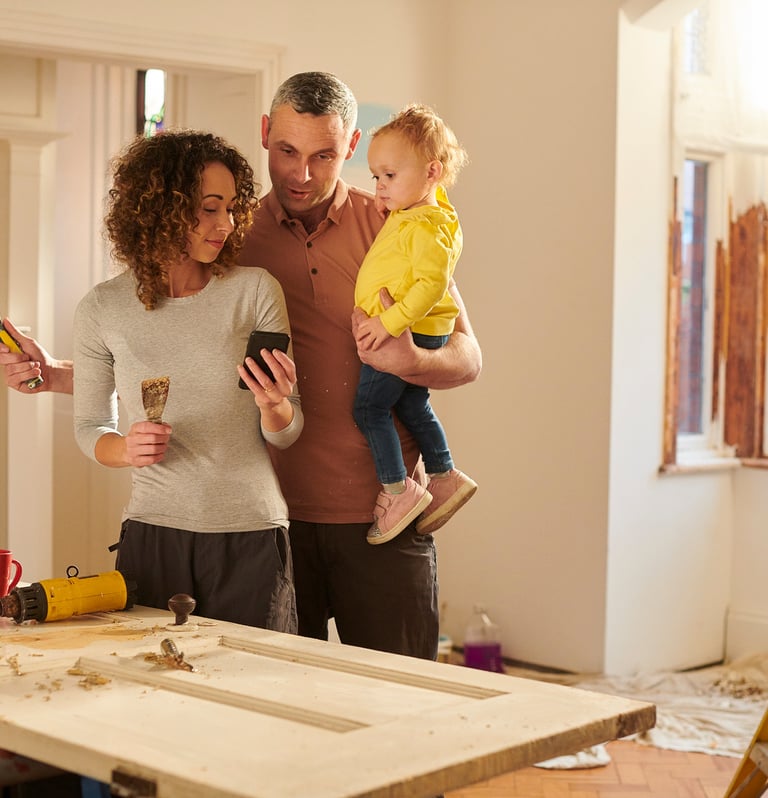 family of three inside a house that's being built