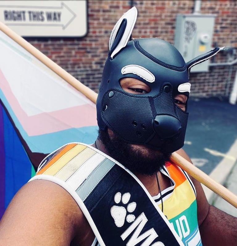 A man in a pup mask walking in a parade.
