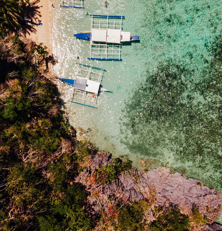 a group of boats docked at a beach