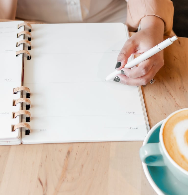virtual assistant holding a pen and writing on a notebook