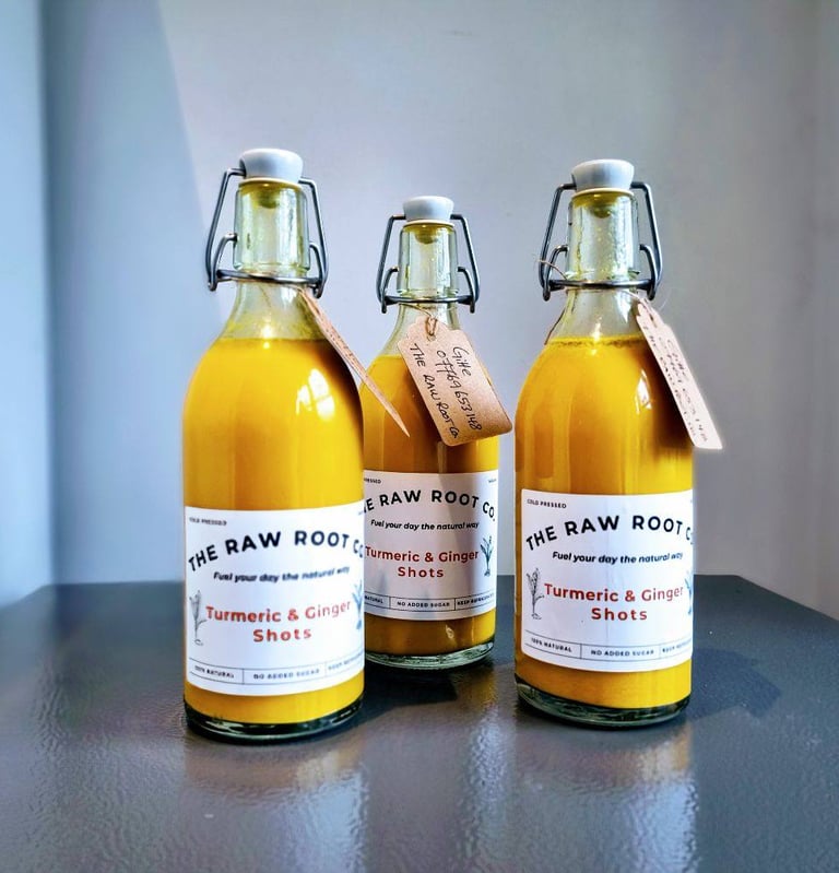 Three bottles of turmeic and ginger health and wellness shots from The Raw Root Co.