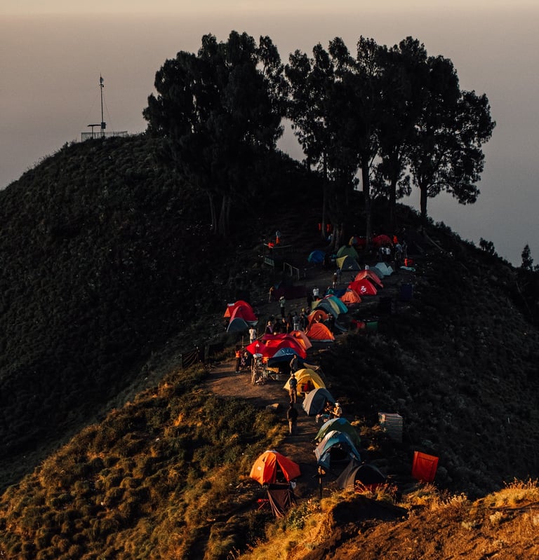 a group of people are gathered around a mountain