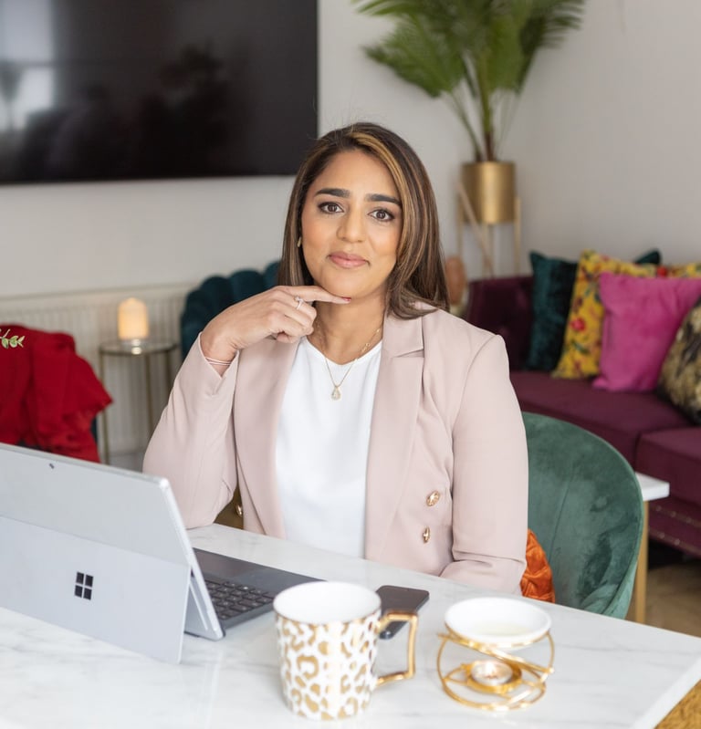 A photo of Anita sitting at a desk