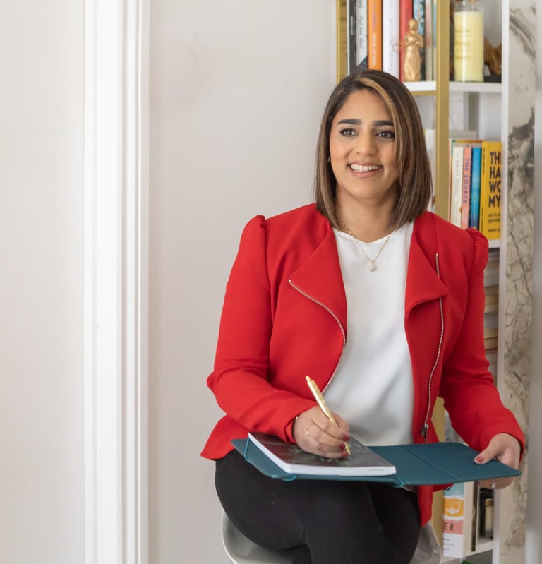 A photo of Anita with a note pad and pen.