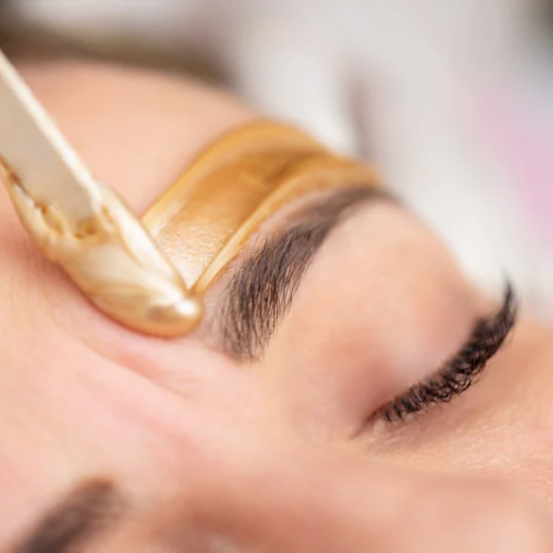 a woman with a gold colored eyeliners and a gold colored eyeliners