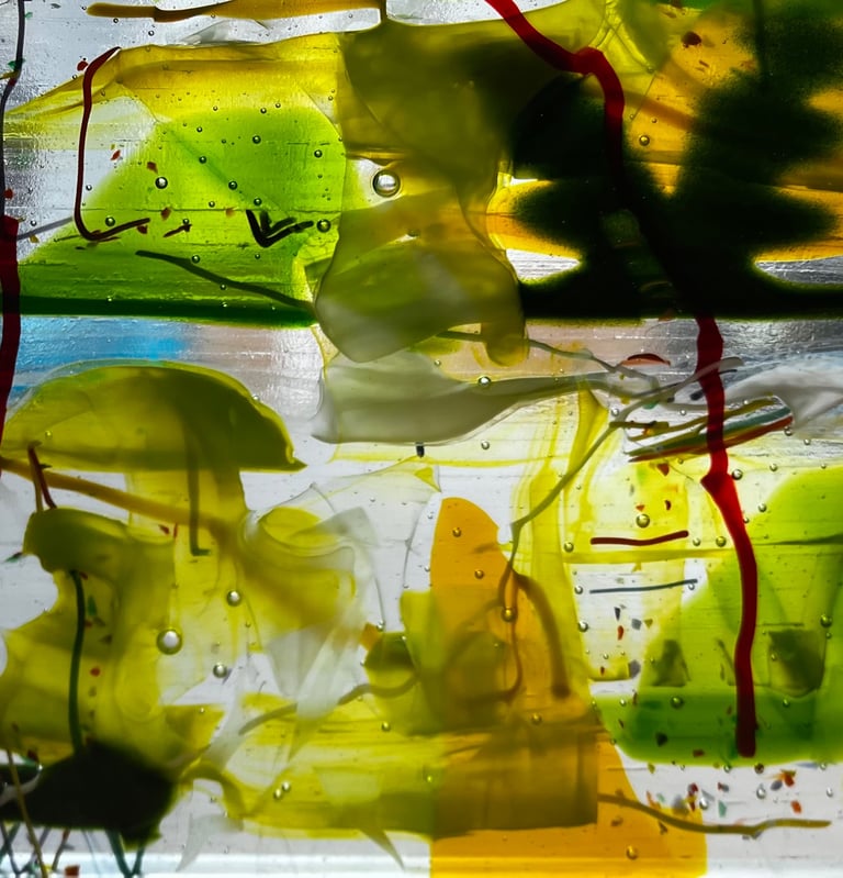 Fused glass abstract art in greens, yellows, oranges and reds