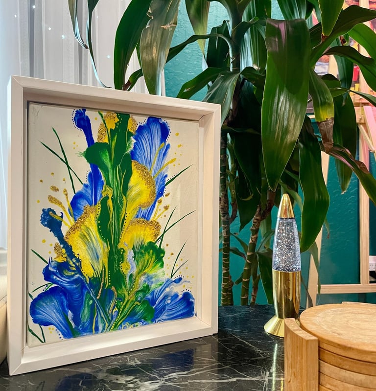an abstract acrylic painting of green, yellow, and blue flowers home decor in a living room.