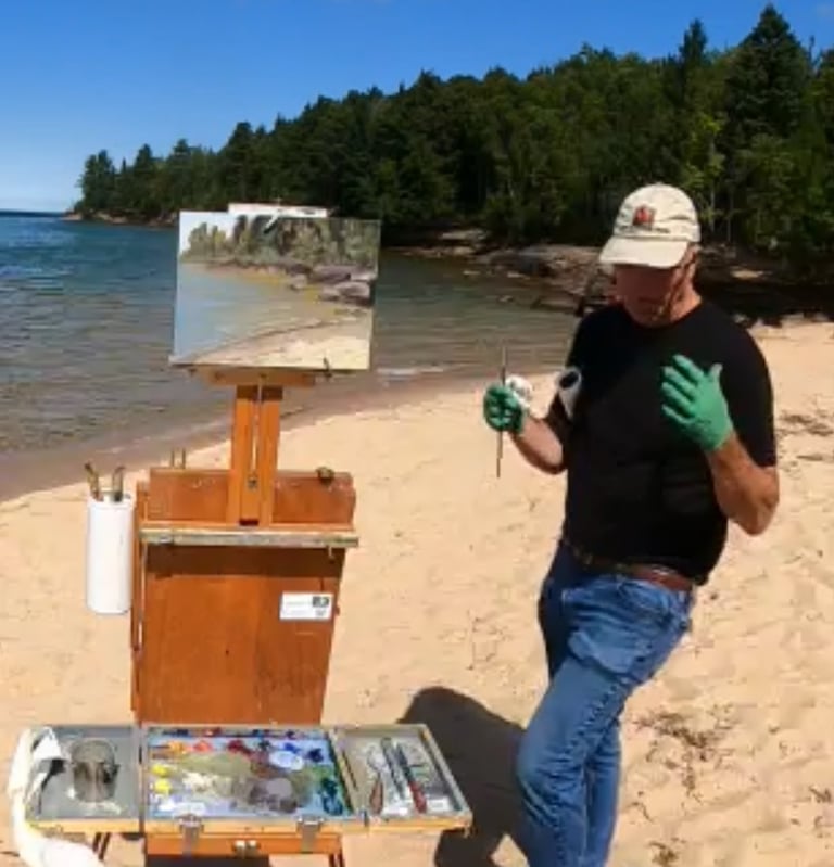 Gary McCaslin giving instructions on painting methods while on location at the beach