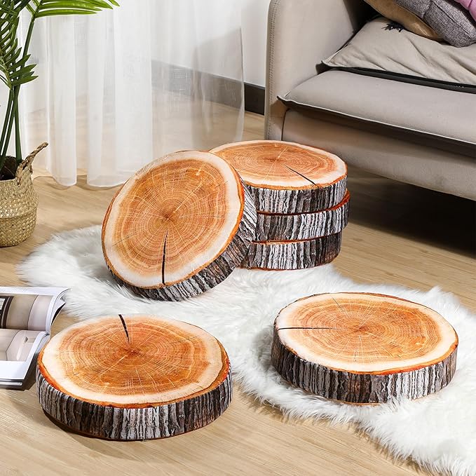 Set of round decorative tree stump floor cushions arranged on a white faux fur rug in a living room.