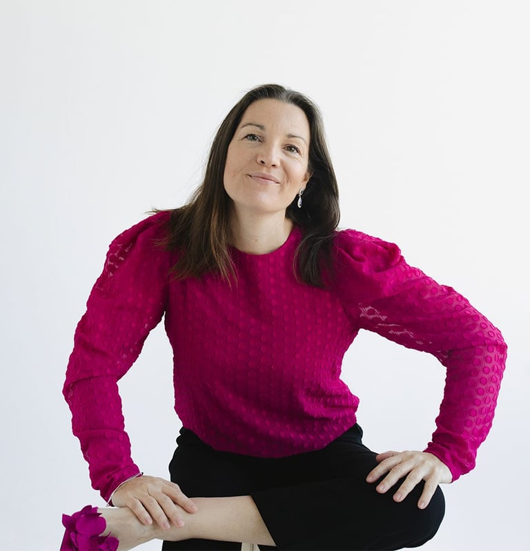 Megan Swan seated on chair smiling