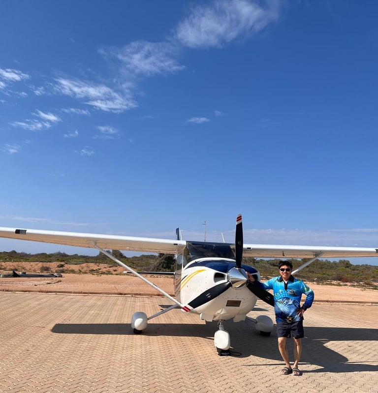 a man standing next to a small plane