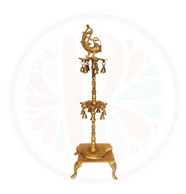 a gold - plated candle holder with bells
