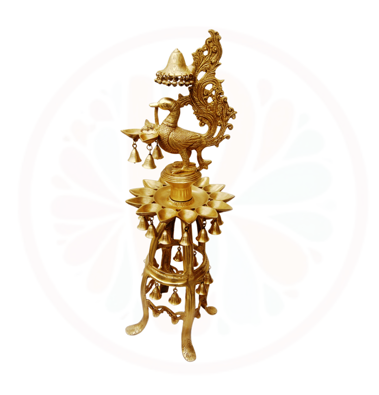 a gold colored clock with a bird on top of it