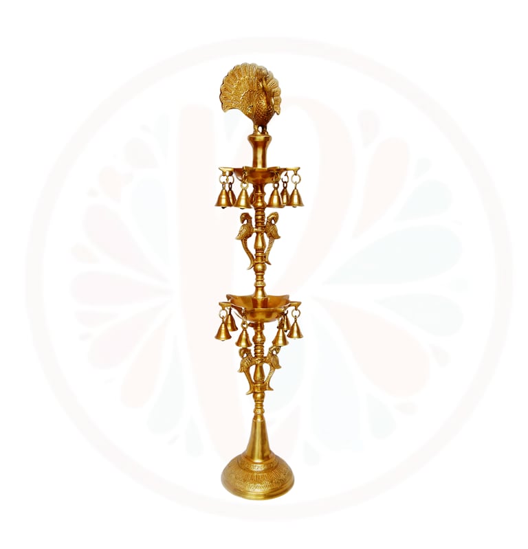 a tall brass candle holder with a fan