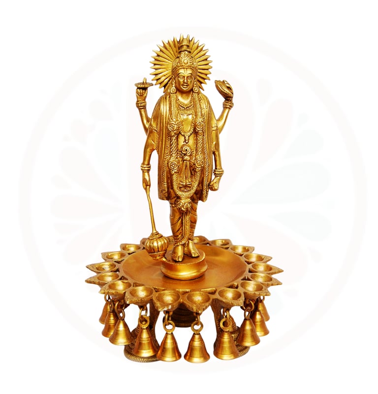 a statue of a vishnu holding a candle and a candle