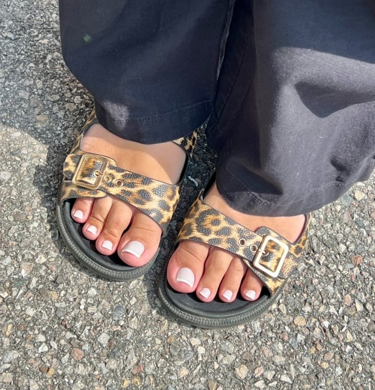a person wearing a leopard print sandals and a leopard print sandals