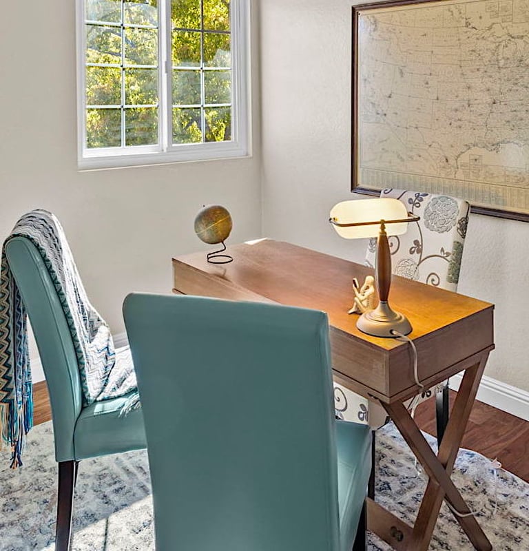 After staging: a desk with a desk and chair in a room