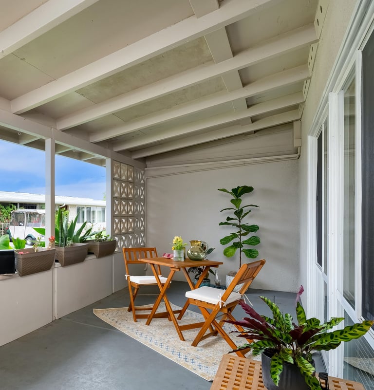 After staging: an unclutered patio with a table and chairs and a couch