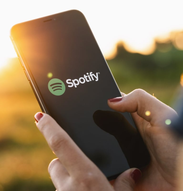 Person holding up phone with Spotify