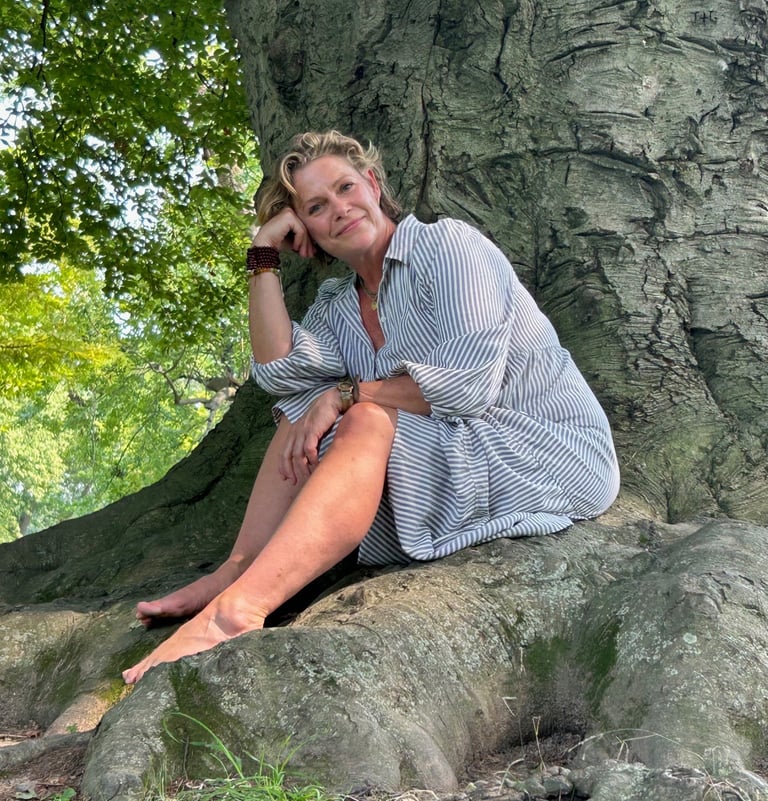 Somatic Arts Practitioner Christina King portrait in front of tree