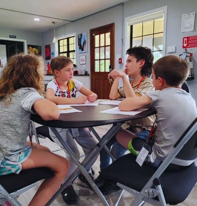 a group of children sitting around a table brainstorming ideas
