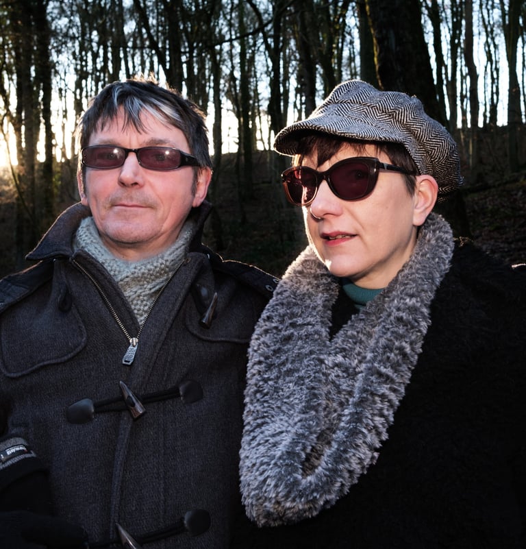 Couple in woods wearing sun glasses
