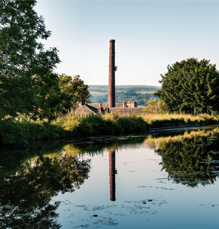 Factory chimney by canal