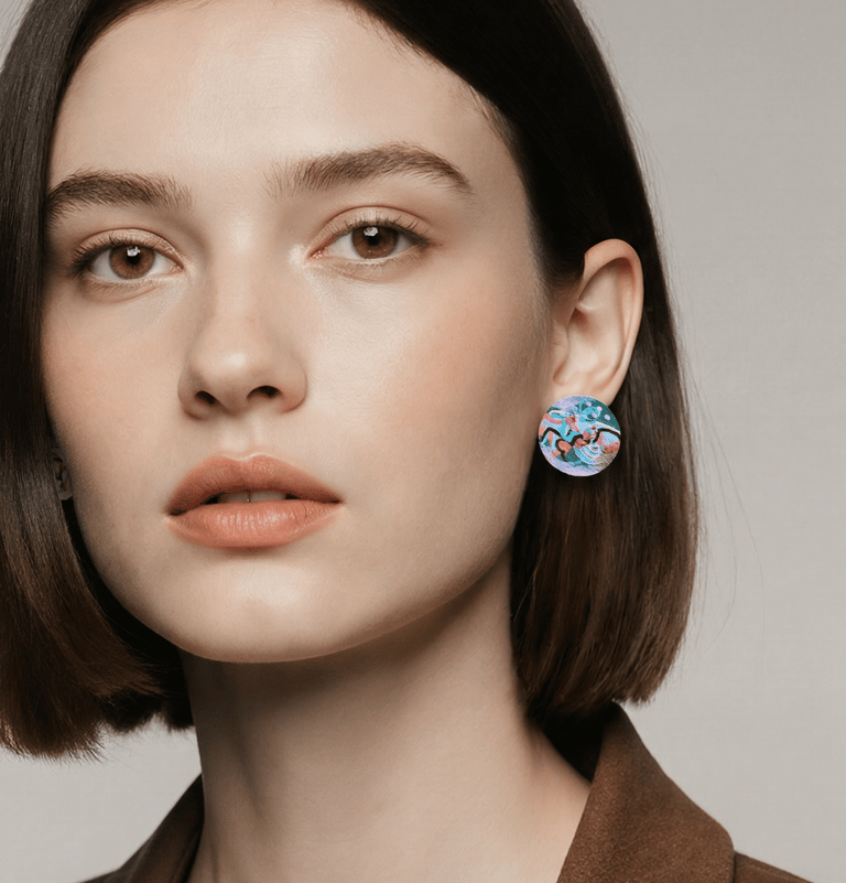 Woman with brown hair wearing colourful handpainted earrings 