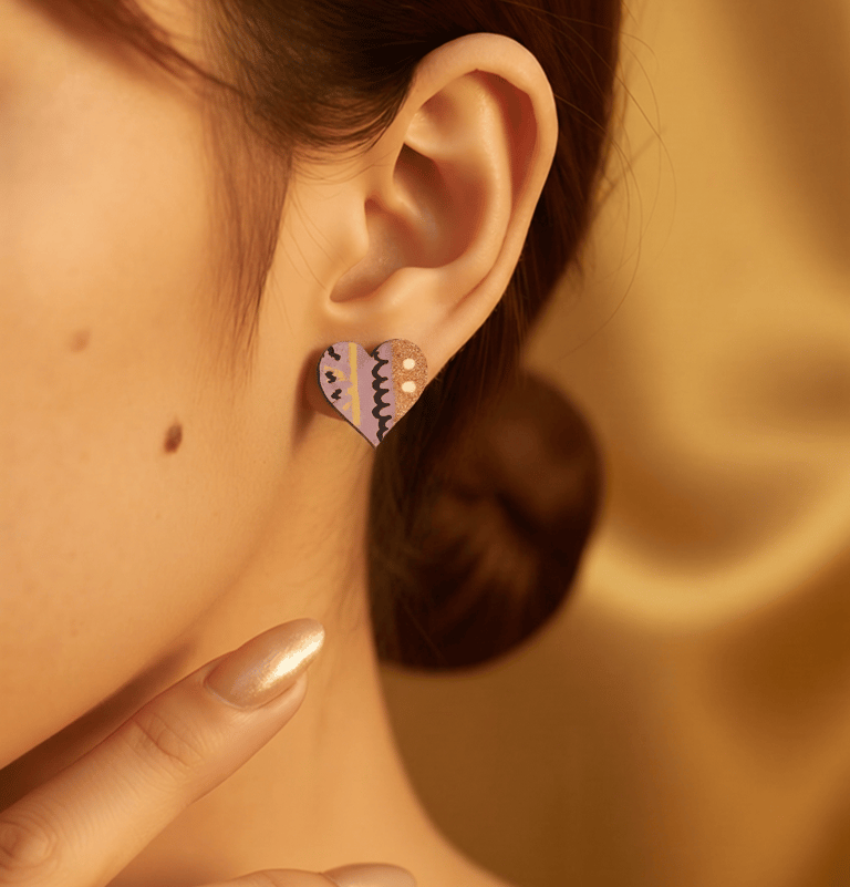 Close up of woman's ear wearing handpainted earring