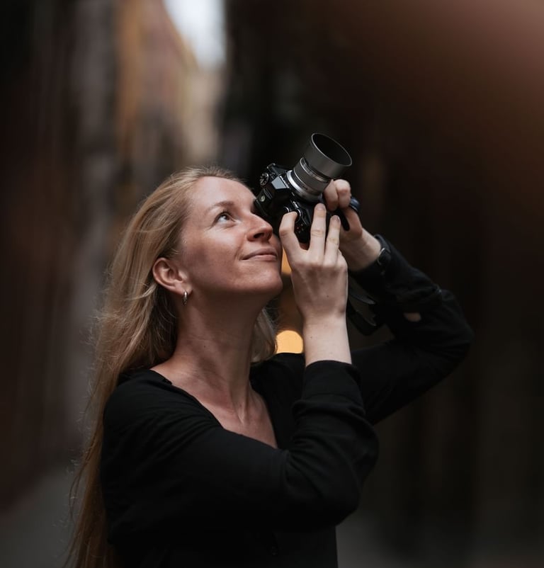 A blonde woman photographer capturing photos with a professional camera in Gothic Quarter