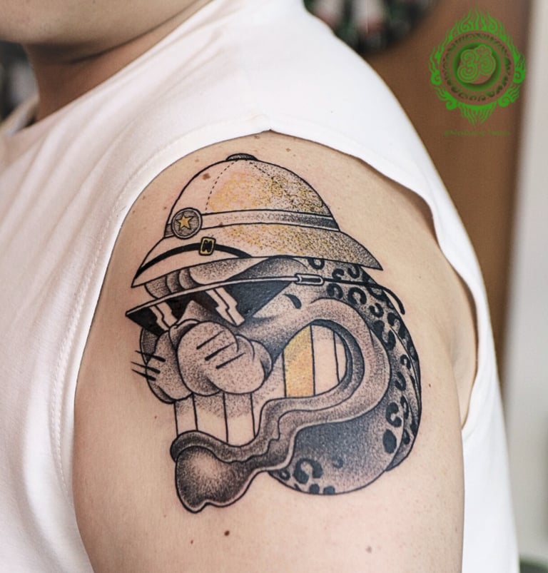 New traditional tattoo of a leopard with sunglasses and a hat on the upper arm