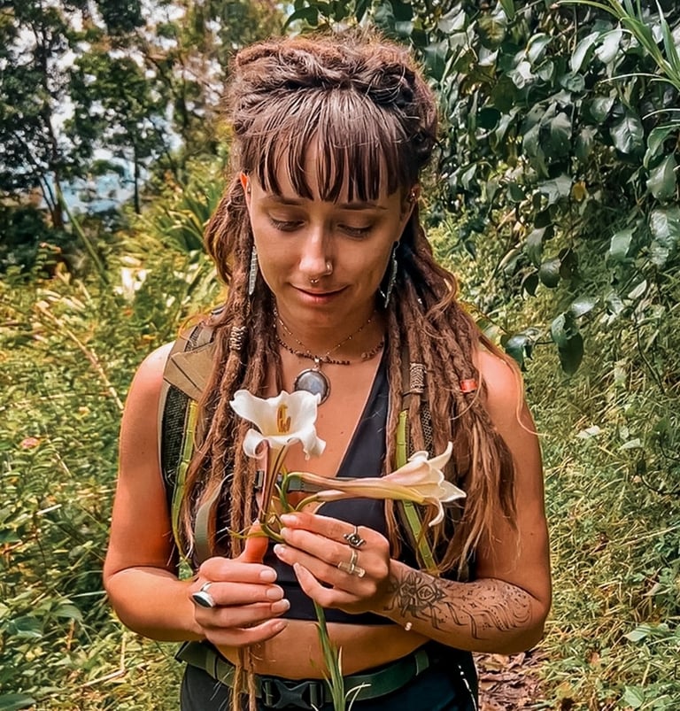 a woman with dreadlocks and dreadlocks holding a flower