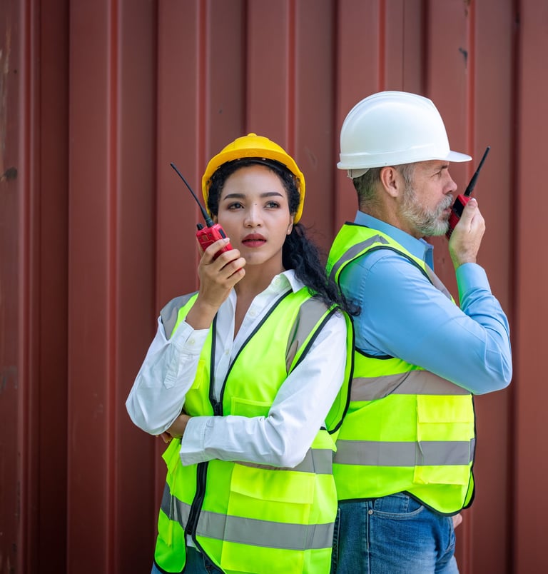 a man and woman in safety vests and hard hats