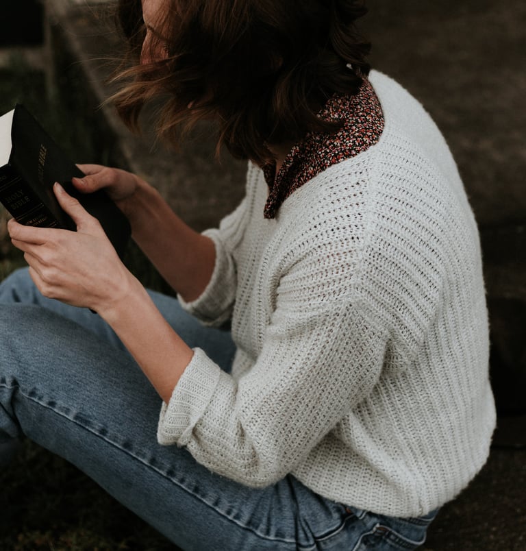 A lady grasping a Bible
