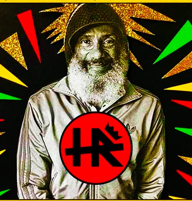 Paul Hudson AKA HR of Bad Brains posing in front of Rasta Reggae background at J Phoenix Booking