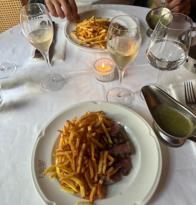Champagne and golden fries served at a sunlit French brasserie table, capturing an effortless luxury moment.