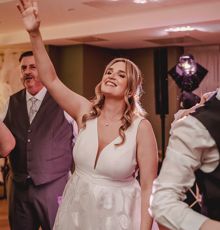 Bride and groom surrounded by friends during celebration in Leeds – wedding photography by The Weddi