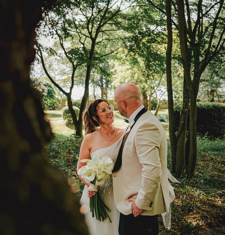 Bride and groom walking hand in hand at Leeds wedding – natural wedding photography by The Wedding E