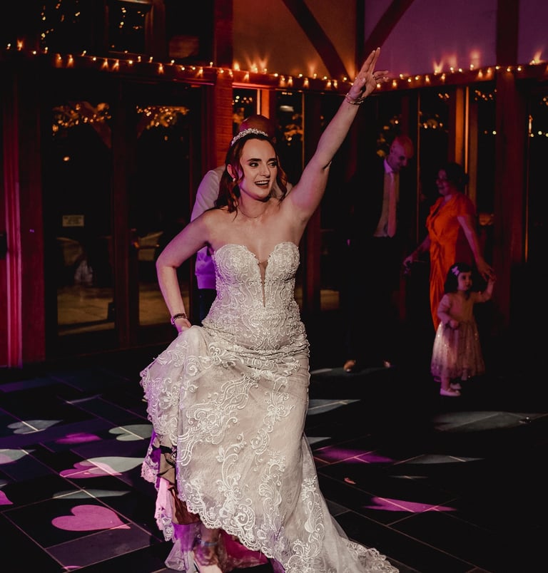 Friends cheering during wedding celebration in Leeds – natural wedding photography by The Wedding Ed