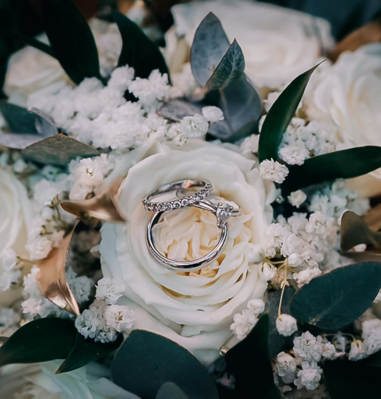Wedding dress hanging in window light in Yorkshire – luxury wedding photography by The Wedding Edit