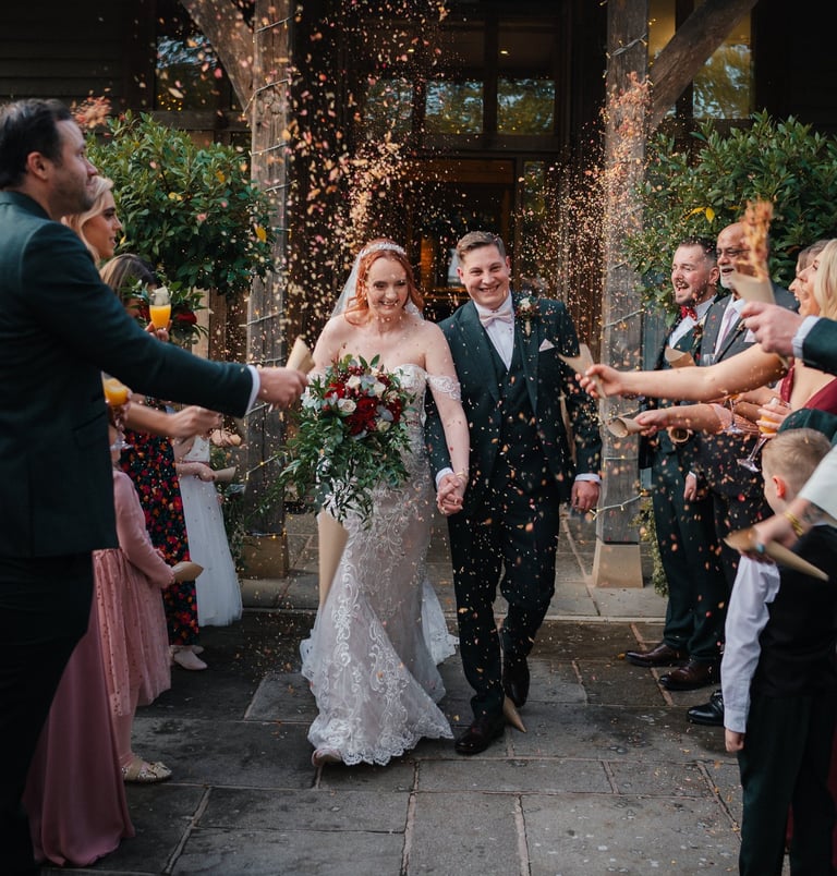 Friends cheering during wedding celebration in Leeds – natural wedding photography by The Wedding Ed