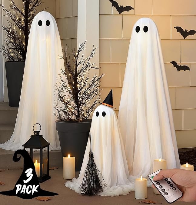 Set of three light-up Halloween ghost decorations with white draped fabric, black eyes, and remote c