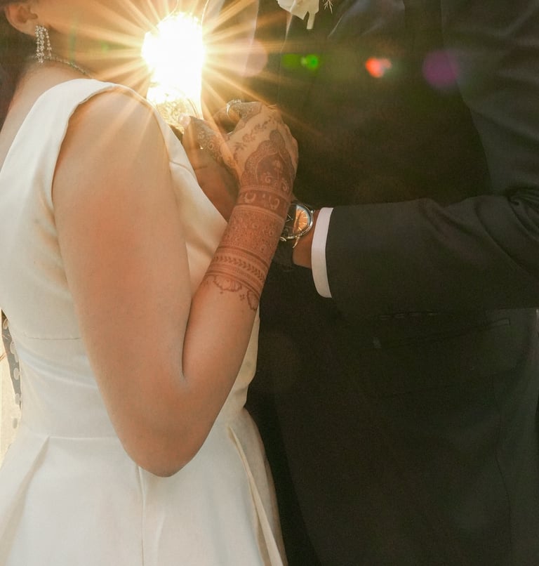 a bride and groom kissing in front of a tree
