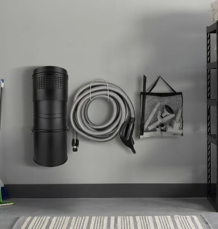 Central Vaccum located in finished garage, hung neatly on wall.