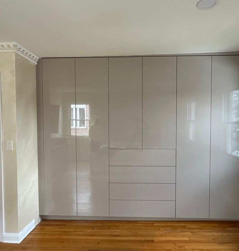 a room with a wooden floor and a white cupboard