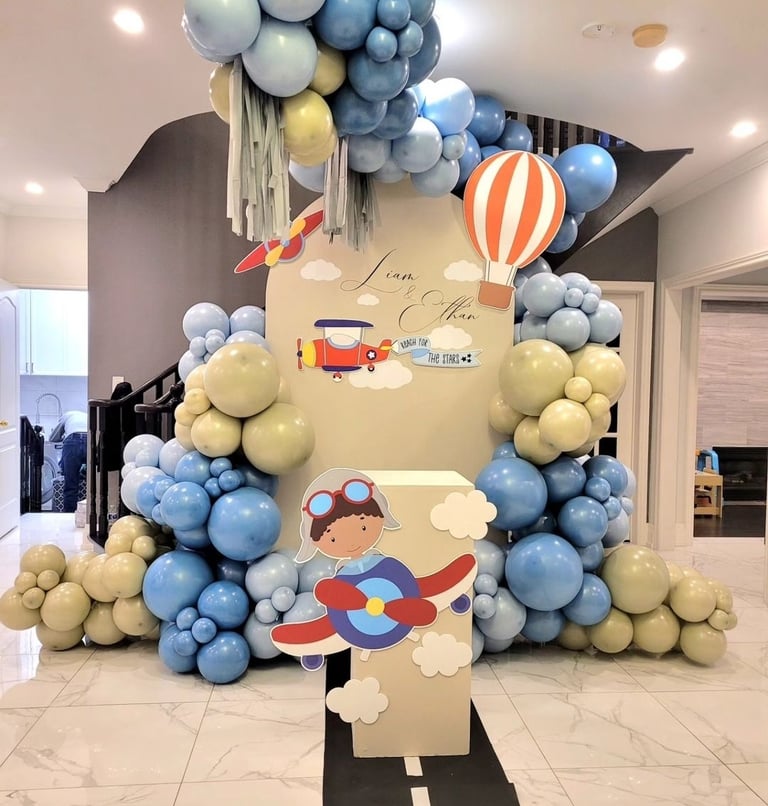 Airplane themed balloon backdrop for two brothers