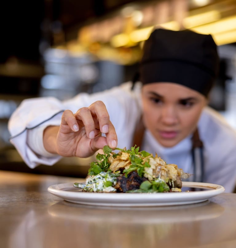 a chef is preparing to serve a meal
